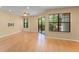 Bright and airy living room with wood floors, ceiling fan, large windows, and a sliding glass door leading to the deck at 609 Northbridge Dr, Altamonte Springs, FL 32714