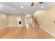 Living room featuring hard surface floors, open view of foyer, stairs, and kitchen, and sliding glass doors to the backyard at 609 Northbridge Dr, Altamonte Springs, FL 32714
