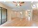 Open-concept living room with wood floors, recessed lighting, ceiling fan, and sliding glass doors leading to the deck at 609 Northbridge Dr, Altamonte Springs, FL 32714