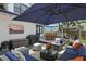 Enjoy this beautiful outdoor living space featuring a cozy seating area with a large umbrella and an outdoor television at 641 E Livingston St, Orlando, FL 32803