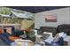 A relaxing outdoor patio with a hot tub, comfortable seating, and a mounted television, perfect for entertaining at 641 E Livingston St, Orlando, FL 32803