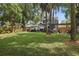 Expansive backyard featuring a large lawn, patio with furniture, and privacy fence at 641 E Livingston St, Orlando, FL 32803