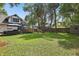 Spacious backyard featuring lush lawn, a firepit, and a privacy fence at 641 E Livingston St, Orlando, FL 32803