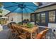 Backyard dining with a wooden table, bamboo chairs and a built-in outdoor grill at 641 E Livingston St, Orlando, FL 32803