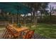 Outdoor dining area offers a serene spot for meals under a large umbrella, surrounded by lush greenery at 641 E Livingston St, Orlando, FL 32803