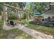 Enjoy the backyard featuring a paved patio with a fire pit, an outdoor dining area, and lush landscaping at 641 E Livingston St, Orlando, FL 32803