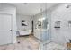 Bright bathroom featuring a clawfoot tub, glass shower, and double vanity with marble countertops at 641 E Livingston St, Orlando, FL 32803