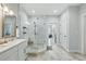 Bathroom featuring a marble walk-in shower, vanity, and neutral stone tile flooring at 641 E Livingston St, Orlando, FL 32803