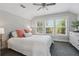 Bedroom featuring an inviting atmosphere with neutral walls, three bright windows, and carpet at 641 E Livingston St, Orlando, FL 32803
