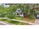 Exterior view of a charming home featuring mature trees and a well-maintained front yard at 641 E Livingston St, Orlando, FL 32803