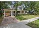 Charming home with well-maintained landscaping, brick driveway, and covered parking at 641 E Livingston St, Orlando, FL 32803