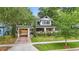 Charming home with an attached carport, lush landscaping, and eye-catching curb appeal at 641 E Livingston St, Orlando, FL 32803
