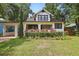 Quaint two-story home with well-maintained lawn, colorful plants, and an attached carport at 641 E Livingston St, Orlando, FL 32803