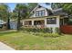 Quaint home featuring a covered porch, classic design, and manicured lawn at 641 E Livingston St, Orlando, FL 32803