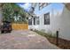 Exterior view of the home with brick driveway and a golf cart parked nearby, showcasing side of house at 641 E Livingston St, Orlando, FL 32803