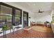 Inviting front porch with stylish seating, a ceiling fan, and brick flooring at 641 E Livingston St, Orlando, FL 32803