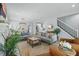 Open-concept living room featuring wood floors and stairs with iron spindles at 641 E Livingston St, Orlando, FL 32803