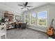 Bright home office featuring a ceiling fan, large window, desk, and built-in bookshelves at 641 E Livingston St, Orlando, FL 32803