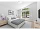 Stylishly staged bedroom featuring bright natural light and contemporary furnishings at 6856 Ebans Bend, Orlando, FL 32807