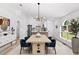 Dining room area with modern table and chairs, open to the kitchen at 6856 Ebans Bend, Orlando, FL 32807