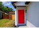 Close-up of a vibrant red front door with modern black hardware at 6856 Ebans Bend, Orlando, FL 32807