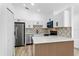 Modern kitchen featuring white cabinets, a decorative backsplash and stainless steel appliances at 6856 Ebans Bend, Orlando, FL 32807