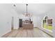 Open-concept kitchen with an island and modern chandelier at 6856 Ebans Bend, Orlando, FL 32807