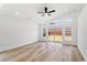 Bright living room featuring wood flooring, vaulted ceilings, and sliding glass doors to the backyard at 6856 Ebans Bend, Orlando, FL 32807