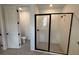 Bathroom showcasing a glass-enclosed walk-in shower with black trim, plus a separate toilet room at 707 Junonia Blvd, New Smyrna Beach, FL 32168