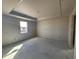 Bright unfinished bedroom featuring a window at 707 Junonia Blvd, New Smyrna Beach, FL 32168