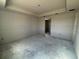 Large unfinished bedroom with tray ceiling and doorway at 707 Junonia Blvd, New Smyrna Beach, FL 32168