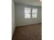 Bright bedroom with two windows offering neighborhood views at 707 Junonia Blvd, New Smyrna Beach, FL 32168