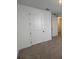 Carpeted bedroom with white doors and neutral walls at 707 Junonia Blvd, New Smyrna Beach, FL 32168