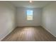 Bright bedroom with natural light and wood laminate flooring at 707 Junonia Blvd, New Smyrna Beach, FL 32168