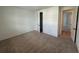 Carpeted bedroom featuring white walls and closet doors at 707 Junonia Blvd, New Smyrna Beach, FL 32168