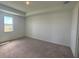 Spacious carpeted bedroom with a large window at 707 Junonia Blvd, New Smyrna Beach, FL 32168