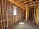 Interior view of a new construction home featuring exposed framing and natural light from a window at 707 Junonia Blvd, New Smyrna Beach, FL 32168