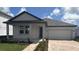 Charming single Gathering home with a two car garage and nicely manicured lawn at 707 Junonia Blvd, New Smyrna Beach, FL 32168