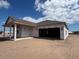 New construction showing covered back porch and framed garage awaiting to be completed at 707 Junonia Blvd, New Smyrna Beach, FL 32168