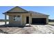 Charming one-story home featuring a covered porch and a two-car garage at 707 Junonia Blvd, New Smyrna Beach, FL 32168