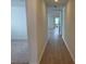 Hallway with hardwood floors leading to open concept room at 707 Junonia Blvd, New Smyrna Beach, FL 32168