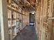 A view of the new construction's hallway with stud frame ready for build out at 707 Junonia Blvd, New Smyrna Beach, FL 32168