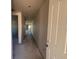 Long hallway leading into the house, with unfinished walls and concrete floors at 707 Junonia Blvd, New Smyrna Beach, FL 32168