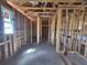 Interior framing showcasing open layout, pre-plumbing, and bright window at 707 Junonia Blvd, New Smyrna Beach, FL 32168