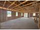Unfinished new construction with exposed wood beams and vapor barrier in a large open room at 707 Junonia Blvd, New Smyrna Beach, FL 32168