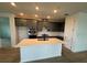 Modern kitchen with stainless steel appliances, island and open to living room at 707 Junonia Blvd, New Smyrna Beach, FL 32168