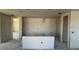 Open kitchen layout with unfinished walls and concrete floors, designed for modern living at 707 Junonia Blvd, New Smyrna Beach, FL 32168