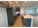 Modern kitchen with stainless steel appliances, island and open to living room at 707 Junonia Blvd, New Smyrna Beach, FL 32168