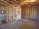 Open-concept living area framed with exposed beams and a glimpse of the entryway at 707 Junonia Blvd, New Smyrna Beach, FL 32168