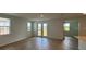 Bright living room with lots of natural light, hardwood floors and access to backyard at 707 Junonia Blvd, New Smyrna Beach, FL 32168